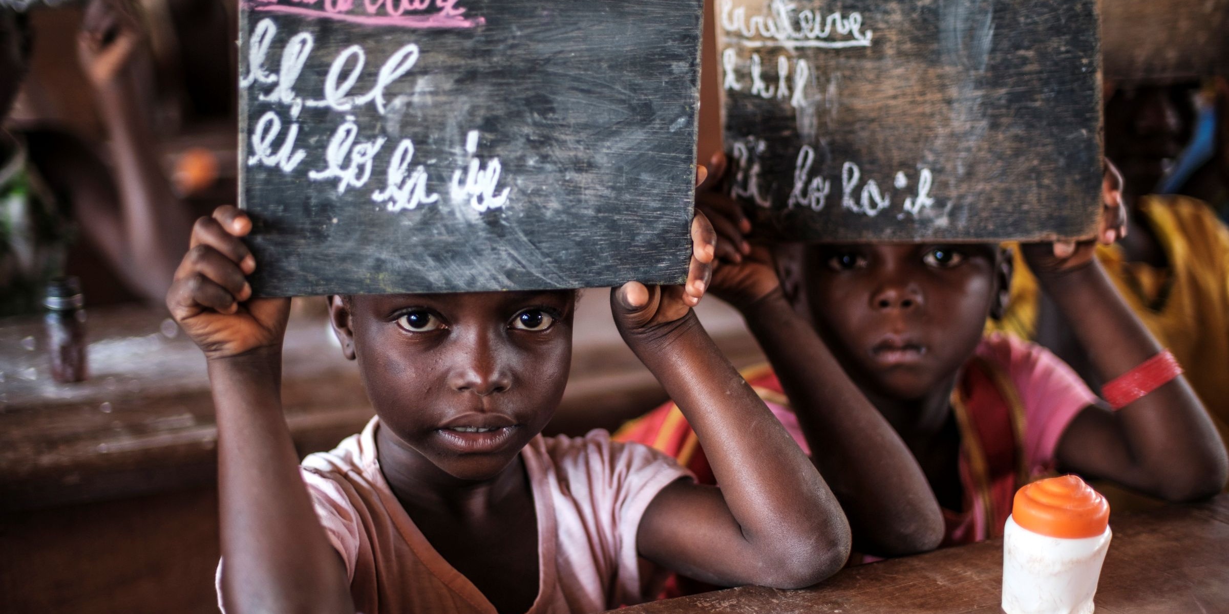 Students reveal their answers on blackboards during a class at the Boyali 2 school, in the village of Boyali, Central African Republic. Credit: GPE/Eduardo Soteras/AP